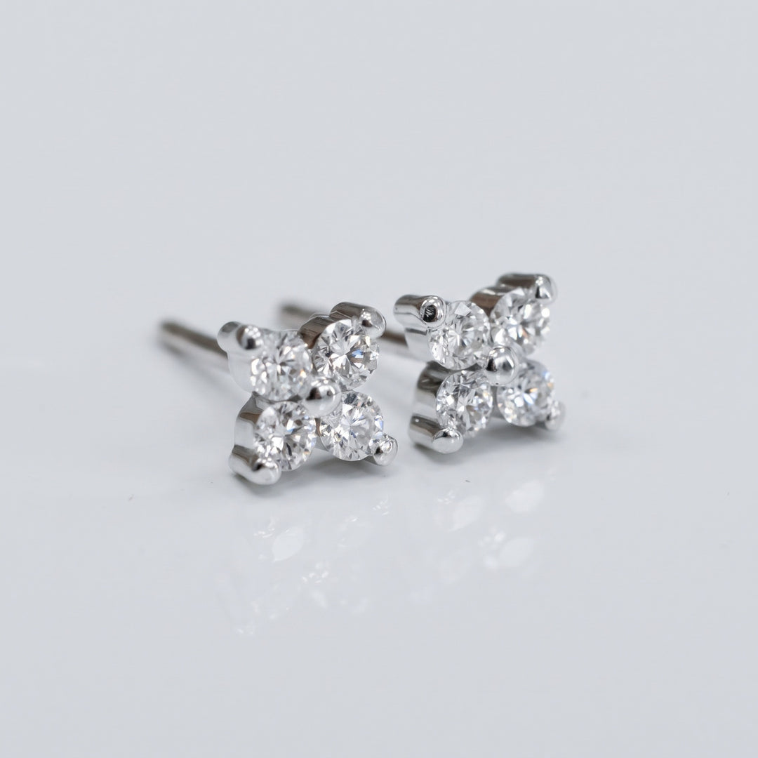 Delicate natural diamond flower stud earrings in 14K white gold — angled view