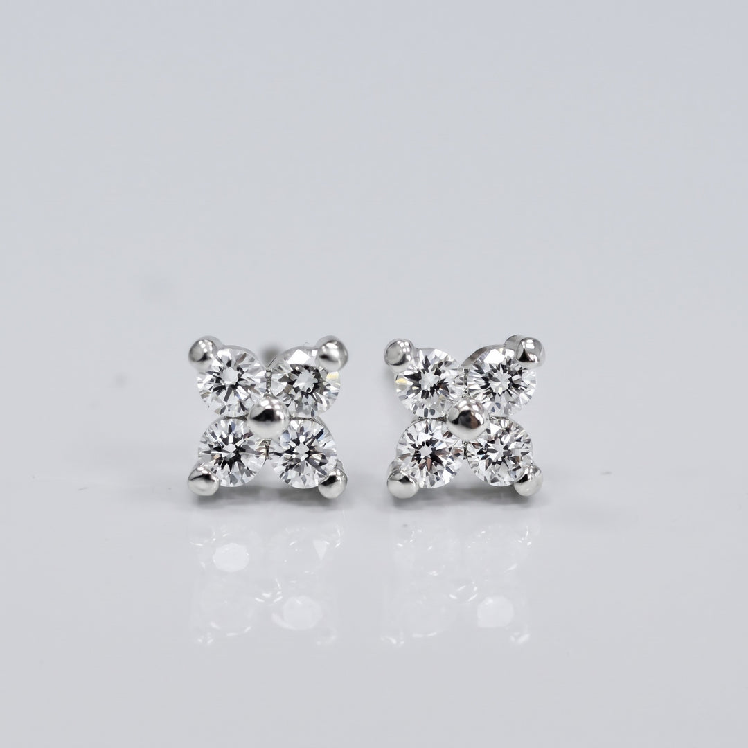 Delicate natural diamond flower stud earrings in 14K white gold — front view