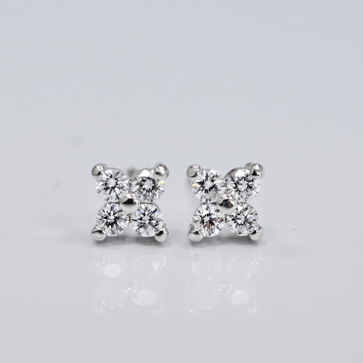 Delicate natural diamond flower stud earrings in 14K white gold — front view