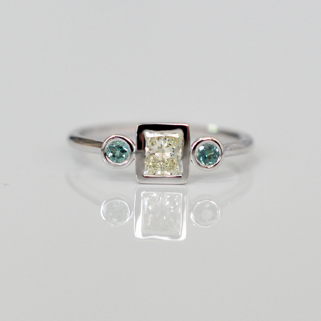 PRINCESS CUT diamond WITH two emeralds